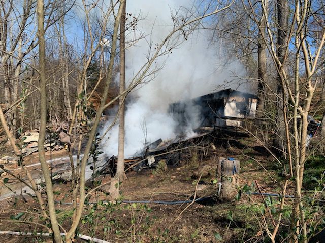 WOMAN ESCAPES BURNING HOME